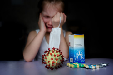 Scared masked little girl sitting around with the Covid-19 virus waiting for the cure. Coronovirus Treatment
