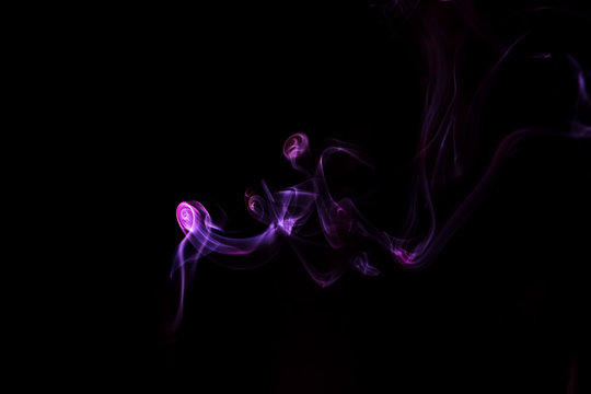 Purple Smoke Against Black Background