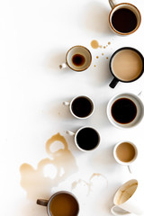 Different cups of coffee on white table top-down space for text