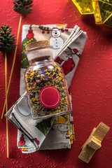 herbal tea in a glass jar on a red background