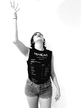 Woman Looking Up With Arms Raised Against White Background