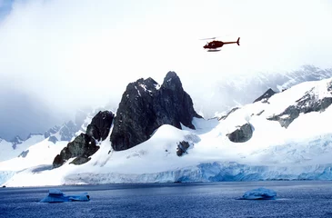 Poster Helicopter patrolling over glaciers and icebergs in Errera Channel at Culberville Island, Antarctica © spiritofamerica