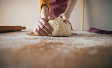 Close up of hands kneading bread dough for baking