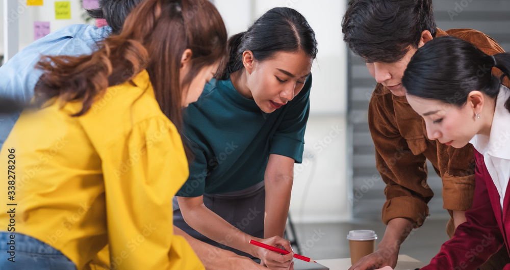 Poster asian ux developer and ui designer brainstorming about mobile app interface wireframe design on meeting table with customer brief and color code at modern office.Creative digital development agency