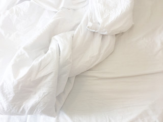 after waking up in the​ morning. The crinkle blanket on the bed in the hotel with the sun​light​ on​ the​ blanket​