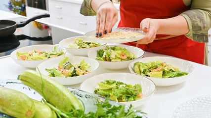 the cook is preparing a salad salad. vegetarian food. cook in the kitchen.