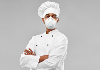 health protection, safety and pandemic concept - indian male chef cook wearing face protective mask...