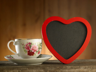 heart shape blackboard and cup of coffee