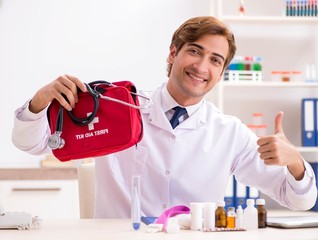 Young doctor with first aid kit in hospital