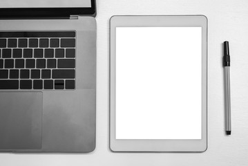 Mock up white digital tablet and notebook and pen for display advertise, black and white tone.