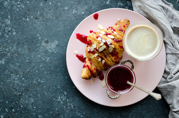 Cup of coffee, croissant and jam