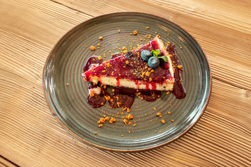 A slice of cheesecake with a caramelized fruit sauce
