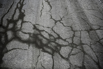asphalt in cracks texture / abstract background cracks on asphalt road