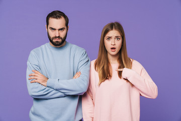 Fototapeta premium Shocked girl pointing to offended boyfriend