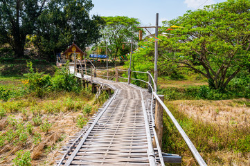 The wooden bridge with rice field at Phrathat San Don temple