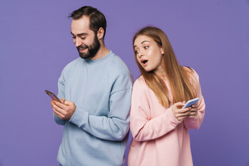 Girl looking at her man chatting by mobile phone