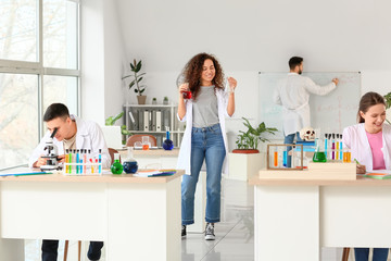 Young people at chemistry lesson in classroom