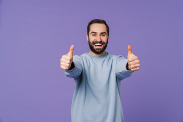 Cheerful happy young man showing thumbs up.