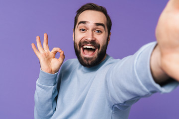 Fototapeta premium Handsome young man take a selfie by camera.