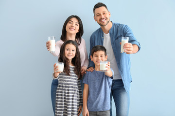 Family drinking milk on color background