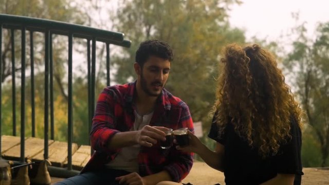 A cute Loving couple on a date cheering with glasses of coffee