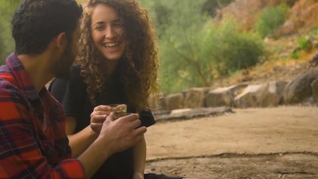 A cute Loving couple on a date cheering with glasses of coffee
