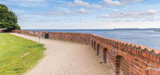 Fototapeta na wymiar Panorama of the red brick wall in the garden of castle Sonderborg, Denmark