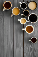Lots of coffee on wooden desk top-down space for text