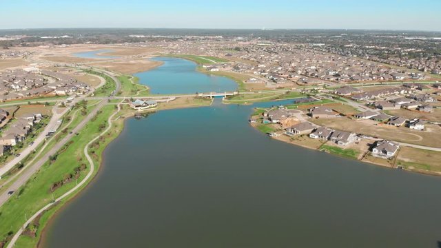 Peaceful Houston neighborhood aerial view. New subdivision in construction aerial view. Beautiful view of a community lake from above. Establishing shot.