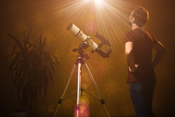 Amateur astronomer looking at the stars with a telescope. Astronomy and astrology concept.