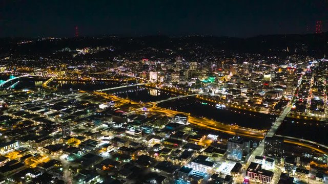 High Altitude Aerial Timelapse Looks Down on City at Night and Shows Network Activity of Individual Vehicles Moving throughout the Metropolis