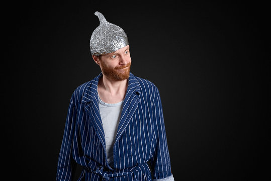 ironic man in foil cap and old holey bathrobe