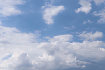 Fototapeta premium Background of beautiful sky. Image of clouds in a blue sky. Texture of white cumulus clouds. Cropped shot, horizontal, close-up, nobody. Concept of natural beauty and ecology.