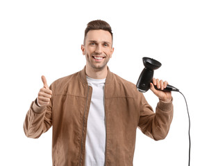 Naklejka premium Handsome young man with hair dryer on white background