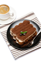 Classic tiramisu dessert on ceramic plate and cup of coffee isolated on white background with clipping path