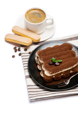 Classic tiramisu dessert on ceramic plate, savoiardi cookies and cup of coffee isolated on white background with clipping path