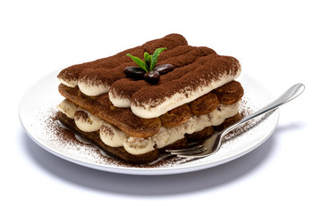 Classic tiramisu dessert on ceramic plate isolated on white background with clipping path