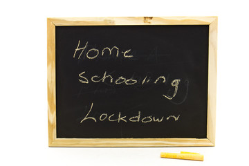 Small blackboard with the words home schooling written on it isolated on a clear background in horizontal format