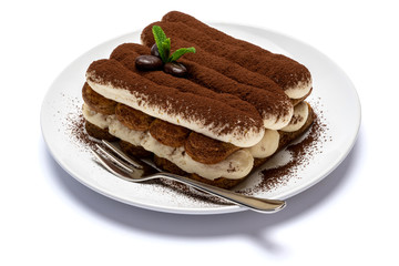 Classic tiramisu dessert on ceramic plate isolated on white background with clipping path