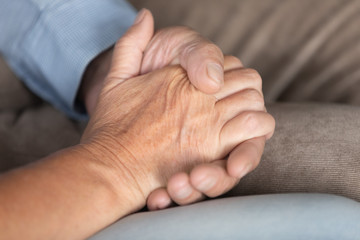Close up older couple holding hands, loving spouses supporting and comforting each other, mature senior family expressing empathy and understanding, good trusted relationship in marriage