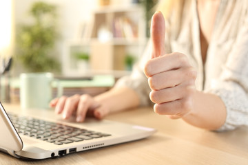Woman hands using laptop with thumbs up