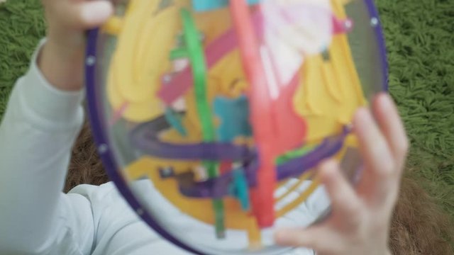 Little girl play with three-dimensional toy puzzle
