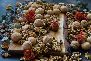 Shelled and shelled walnuts on a wooden board on the table. Healthy nutrition, vegetarianism, diet.