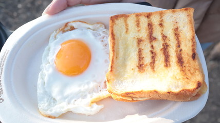 Breakfast is toast and fried eggs.