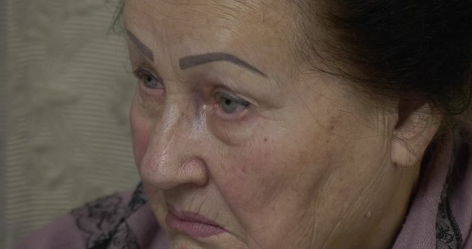 A close-up of a grandmothers face that with live interest happens to be a granddaughter's story. The expressive texture of an elderly woman's close-up is emotionally active.