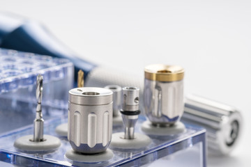 Closeup/ Implant surgical kits/ mini screw/ screw driver/ drilling bits on white background.