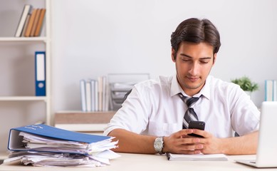 Young handsome businessman working in office