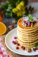 Delicious fresh beautiful pancakes with citrus honey and jam