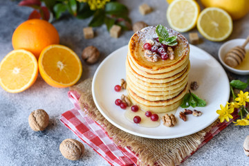 Delicious fresh beautiful pancakes with citrus honey and jam