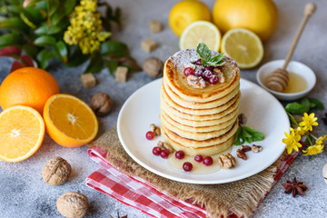Delicious fresh beautiful pancakes with citrus honey and jam
